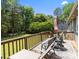 Beautiful outdoor deck with seating and a view of the wooded backyard at 5006 Crooked Oak Ln, Charlotte, NC 28226