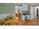 Breakfast nook with wainscotting has a built-in desk and a view into the living room at 5006 Crooked Oak Ln, Charlotte, NC 28226