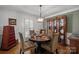 Elegant dining room with a round table, upholstered chairs, and a decorative china cabinet, perfect for entertaining at 5006 Crooked Oak Ln, Charlotte, NC 28226