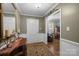 Elegant home entryway featuring hardwood floors, a decorative rug, and classic wainscoting, leading into the living spaces at 5006 Crooked Oak Ln, Charlotte, NC 28226