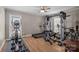 Bright exercise room with complete gym, wood floors, and natural light at 5006 Crooked Oak Ln, Charlotte, NC 28226