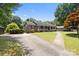 This home has an inviting front porch, charming architectural details, and mature landscaping at 5006 Crooked Oak Ln, Charlotte, NC 28226