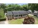 Charming one-story home with a welcoming front porch, brick accents, and well-maintained landscaping at 5006 Crooked Oak Ln, Charlotte, NC 28226