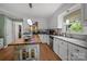 Well-lit kitchen with white cabinets, a center island, and stainless steel appliances, perfect for culinary creations at 5006 Crooked Oak Ln, Charlotte, NC 28226