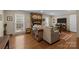 Comfortable living room features a brick fireplace, hardwood floors, and plenty of natural light at 5006 Crooked Oak Ln, Charlotte, NC 28226