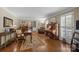 Spacious living room with hardwood floors, large windows with shutters, and elegant furnishings, creating a warm ambiance at 5006 Crooked Oak Ln, Charlotte, NC 28226