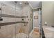 Walk-in shower with glass doors and neutral toned tiling and decor at 5006 Crooked Oak Ln, Charlotte, NC 28226