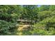 Wood home surrounded by trees featuring green grass and a front porch at 5212 Timber Creek Ct, Kings Mountain, NC 28086