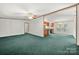 Open concept living room with green carpet and kitchen view at 5212 Timber Creek Ct, Kings Mountain, NC 28086