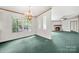 Living room with green carpet, three windows, a fireplace, and decorative chandelier at 5212 Timber Creek Ct, Kings Mountain, NC 28086