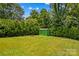 Green shed nestled amongst trees and grass in the home's expansive backyard at 564 Greenway Dr, Statesville, NC 28677