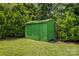 Green shed in the expansive, well-manicured backyard is perfect for storage at 564 Greenway Dr, Statesville, NC 28677
