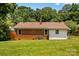 Lush backyard with brick house, red roof, manicured lawn, ideal for relaxation and entertainment at 564 Greenway Dr, Statesville, NC 28677