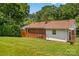 Expansive backyard features lush green grass, brick home, and ample space for outdoor activities at 564 Greenway Dr, Statesville, NC 28677
