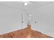 White bedroom with hardwood floors and two doors at 564 Greenway Dr, Statesville, NC 28677