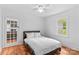 Bedroom with ceiling fan and hardwood floors with a view into the kitchen at 564 Greenway Dr, Statesville, NC 28677