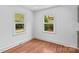 Bright bedroom with hardwood floors, two windows, and ample natural light at 564 Greenway Dr, Statesville, NC 28677