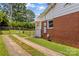 Brick home featuring a private driveway with chain-link fencing in a spacious backyard at 564 Greenway Dr, Statesville, NC 28677