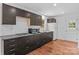 Bright kitchen featuring dark wood cabinets, gas range, and stainless steel appliances at 564 Greenway Dr, Statesville, NC 28677
