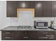 Gas range and microwave above dark wood cabinets and subway tile backsplash at 564 Greenway Dr, Statesville, NC 28677