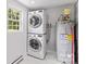 Functional laundry room includes stacked washer/dryer, water heater, and bright window at 564 Greenway Dr, Statesville, NC 28677