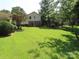Large grassy backyard with mature trees at 5823 Rupert Ln, Charlotte, NC 28215