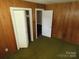 Bedroom featuring vertical wood paneling, closet, and interior door at 5823 Rupert Ln, Charlotte, NC 28215