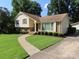Traditional home with a sidewalk leading up to the front door, surrounded by a well-kept lawn and landscaping at 5823 Rupert Ln, Charlotte, NC 28215