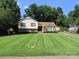 Charming two-story home featuring a well-manicured lawn and mature trees at 5823 Rupert Ln, Charlotte, NC 28215