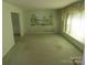 Bright living room with vintage wallpaper and large window at 5823 Rupert Ln, Charlotte, NC 28215
