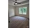 Comfortable bedroom boasts neutral walls, sleek floors, natural light, and a ceiling fan at 723 Taylor St, Rock Hill, SC 29730