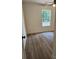 A light-filled bedroom featuring wood-look floors and a large window offering views of the green outdoors at 723 Taylor St, Rock Hill, SC 29730
