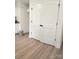 A closet with white, paneled, bi-fold doors and black hardware on top of wood-look floors at 723 Taylor St, Rock Hill, SC 29730