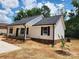 Well maintained single story home with neutral siding, dark shutters, and green vegetation at 723 Taylor St, Rock Hill, SC 29730