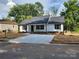 Charming home showcasing a large driveway and fresh landscaping at 723 Taylor St, Rock Hill, SC 29730