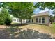 Backyard and patio with an additional screened-in patio and mature trees at 7406 Carolina Jessamine Ct, Indian Land, SC 29707
