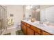 Bright bathroom featuring a double vanity, a large mirror, and a glass enclosed shower at 7406 Carolina Jessamine Ct, Indian Land, SC 29707