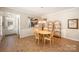Bright dining area featuring wood floors, a chandelier, and a view into the kitchen at 7406 Carolina Jessamine Ct, Indian Land, SC 29707