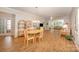 Open-concept dining room with wood floors, a chandelier, and seamless flow to living spaces at 7406 Carolina Jessamine Ct, Indian Land, SC 29707