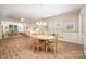 Dining room with wood floors, natural light, and a view of the adjacent living areas at 7406 Carolina Jessamine Ct, Indian Land, SC 29707