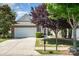 Charming brick front home with a two-car garage, beautiful landscaping, and a well-maintained lawn at 7406 Carolina Jessamine Ct, Indian Land, SC 29707