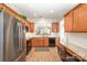 Kitchen features wood cabinets, granite countertops, stainless steel appliances, and wood floor at 7406 Carolina Jessamine Ct, Indian Land, SC 29707