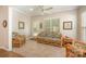 Sunroom features rattan furniture, tile floor and abundant natural light from large windows at 7406 Carolina Jessamine Ct, Indian Land, SC 29707