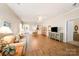 Spacious living room featuring wood floors, neutral paint, and seamless flow to the dining area at 7406 Carolina Jessamine Ct, Indian Land, SC 29707