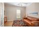 Office with wood floors, leather couch, colorful rug, and natural light from large window at 7406 Carolina Jessamine Ct, Indian Land, SC 29707