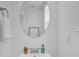 Close-up of a bathroom sink with a circular mirror and minimal decor at 9212 Delancey Ln # 63, Concord, NC 28027