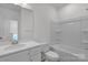 A well-lit bathroom featuring a tub-shower combo with a white vanity and countertop at 9212 Delancey Ln # 63, Concord, NC 28027