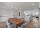 Open-concept dining and kitchen space with a wooden table at 9212 Delancey Ln # 63, Concord, NC 28027