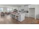Modern kitchen with white cabinetry, quartz countertops, and stainless steel appliances at 9212 Delancey Ln # 63, Concord, NC 28027