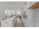 Modern kitchen with white cabinetry, quartz countertops, and stainless steel appliances at 9212 Delancey Ln # 63, Concord, NC 28027